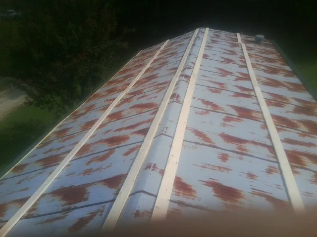 Rusted metal roof panels with new wood purlins before replacement — Storm Damage Roof Repair in Housatonic by Roofing Brothers