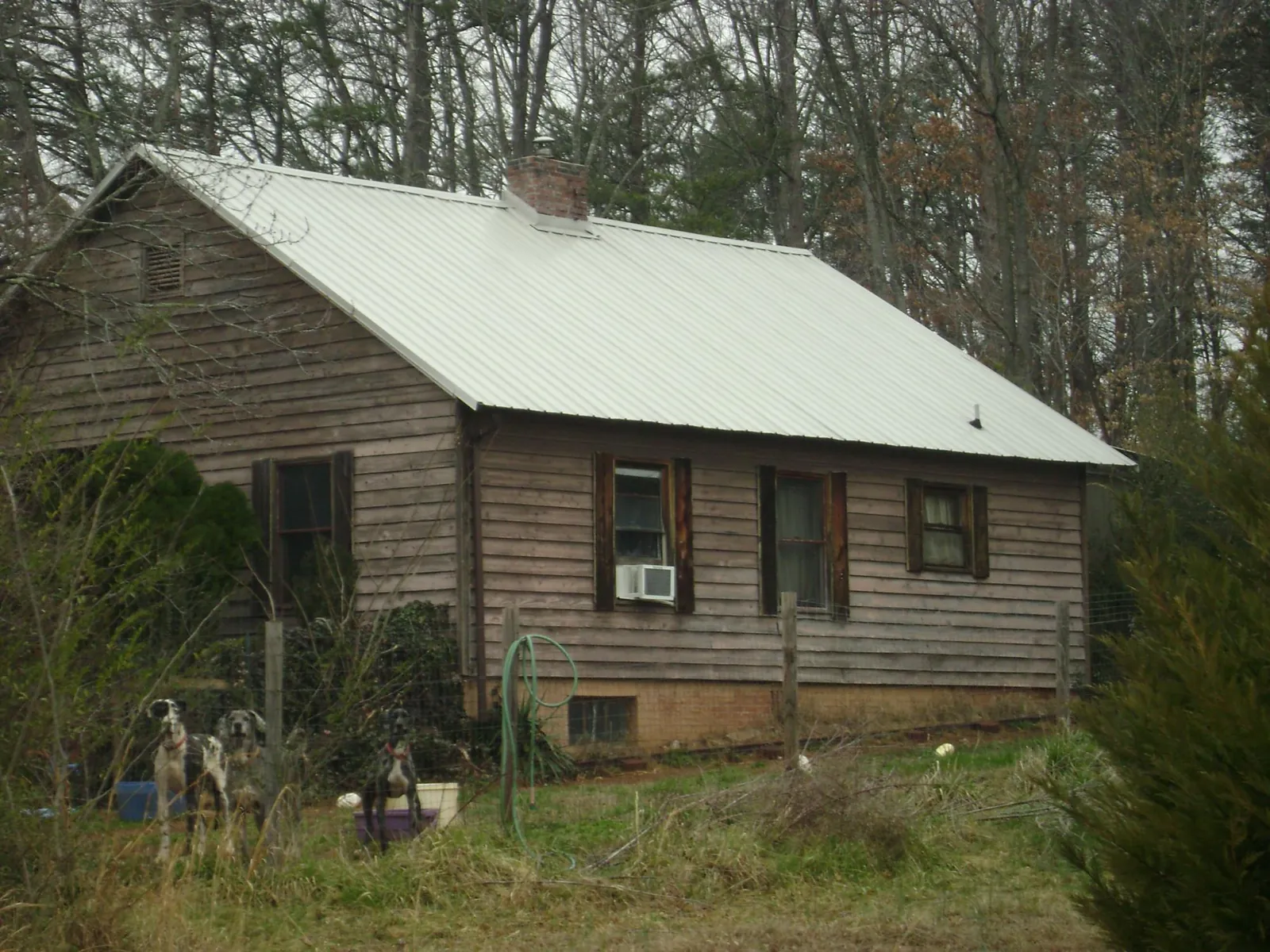 White metal roof on an old wood sided farmhouse, from a Metal Roof Installation job in Housatonic